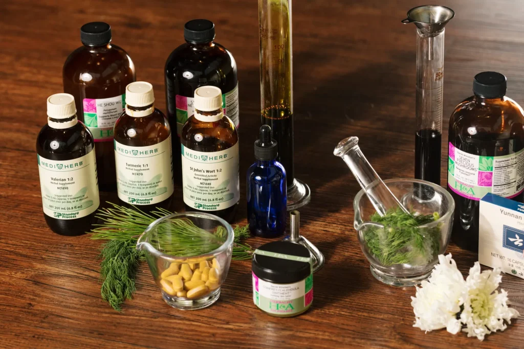 Holistic medicines and ingredients arranged neatly on wood surface